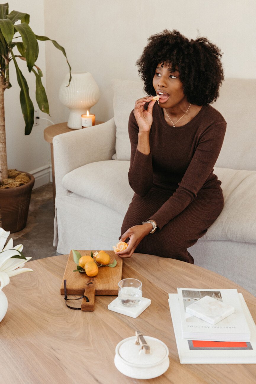 Woman eating citrus.