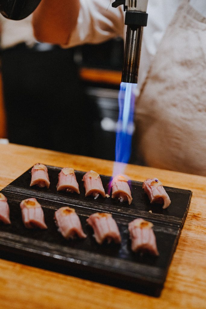 sushi being tortched sushi by scratch restaurants