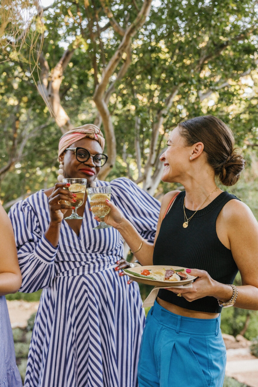 Women clinking wine glasses.