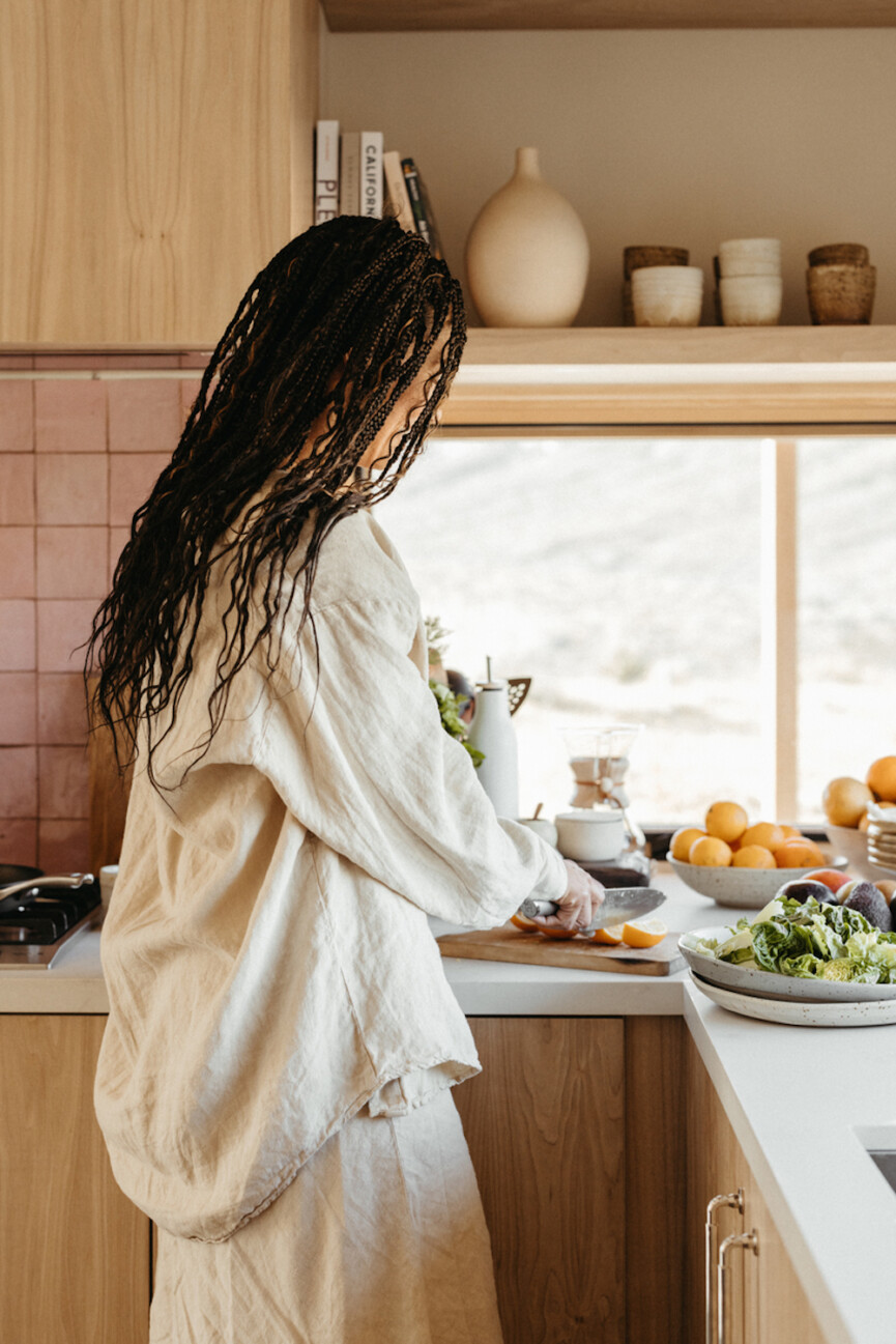woman cooking in kitchen_spring ingredients for gut health