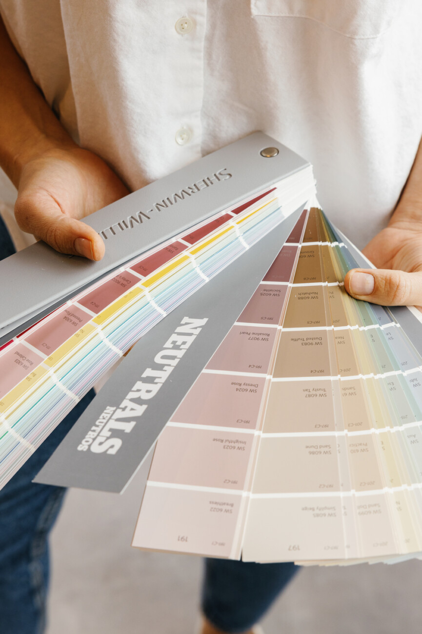 Woman selecting paint swatches.