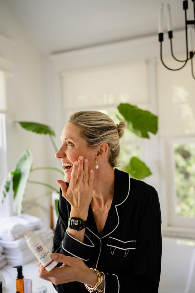 Woman applying skincream.