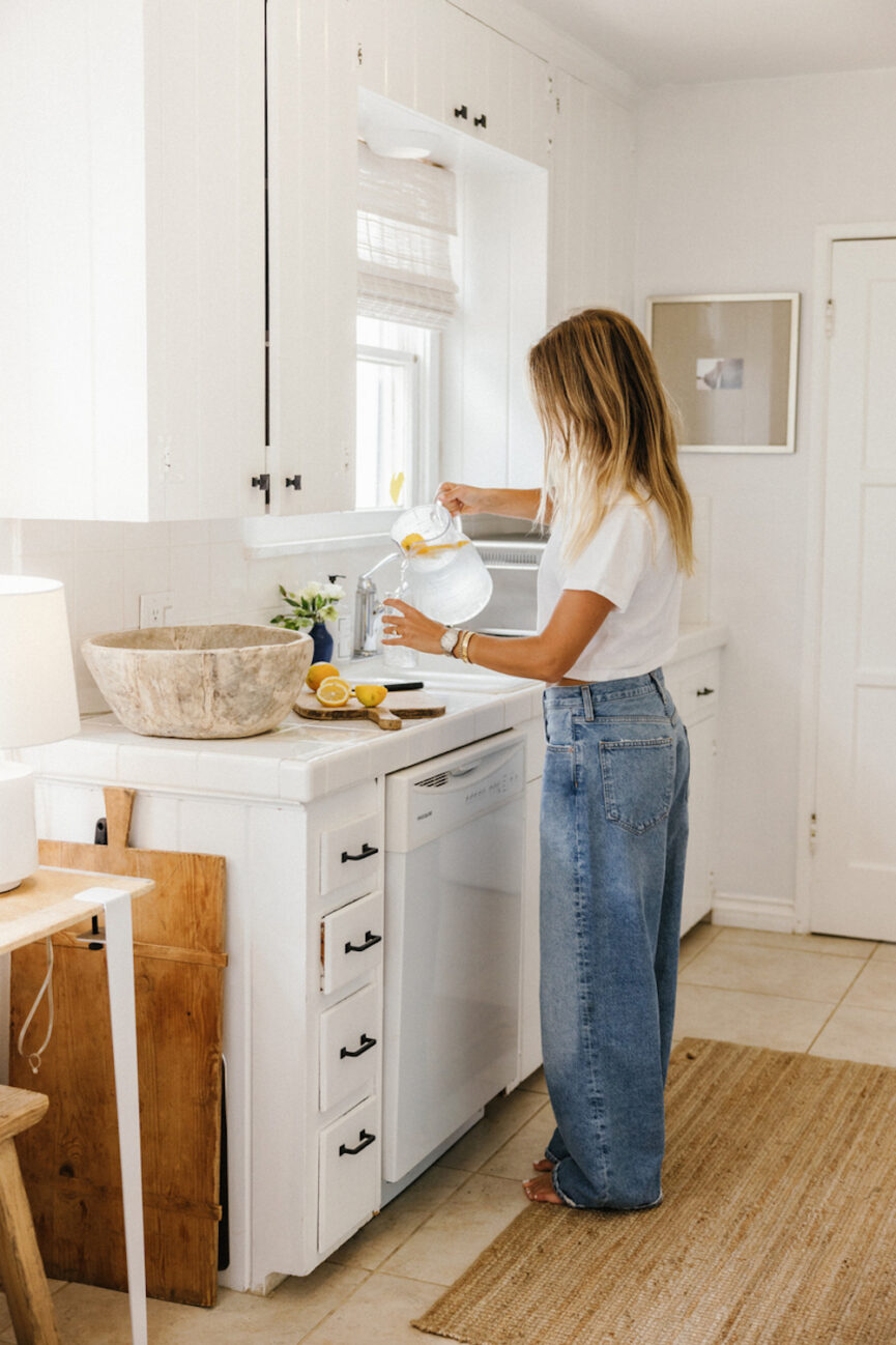 Woman making lemon water.