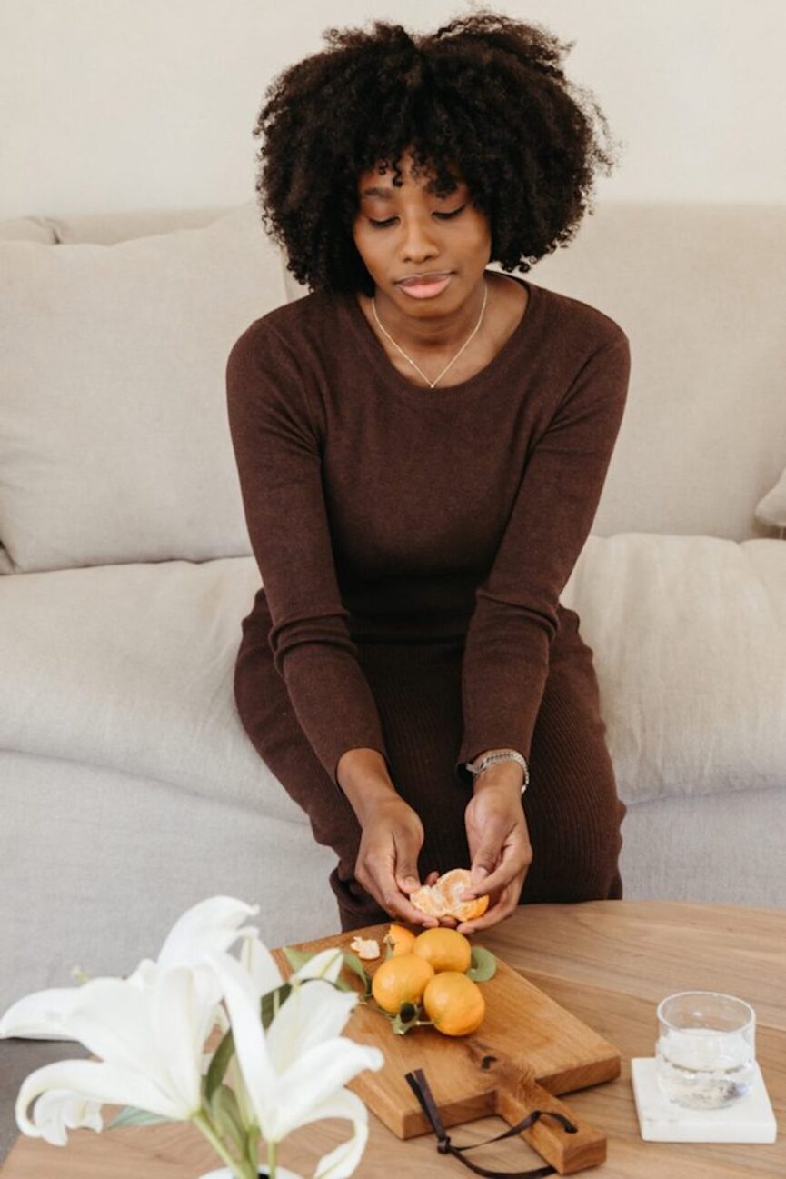 Woman peeling citrus.
