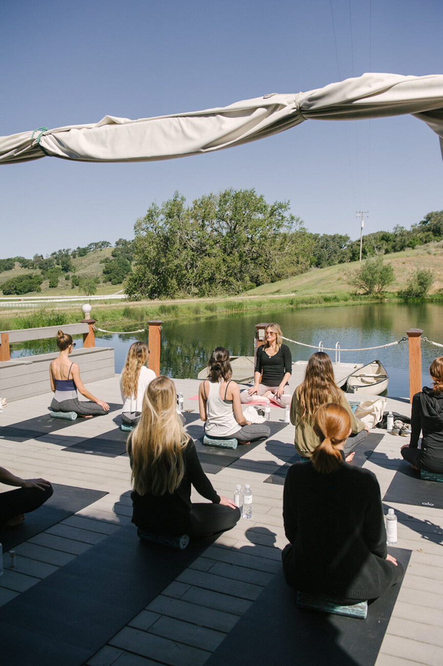 Women doing yoga outside.