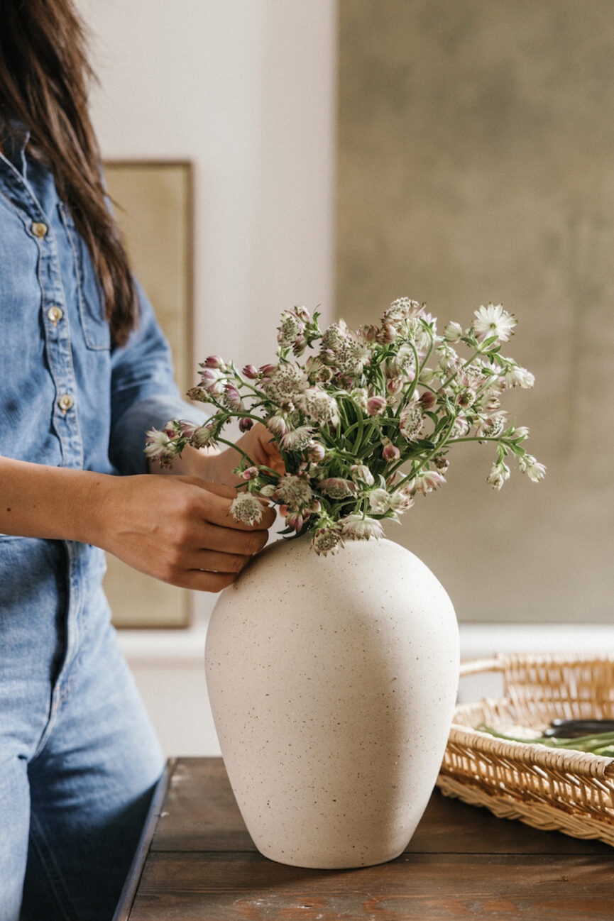 Woman arranging flowers.