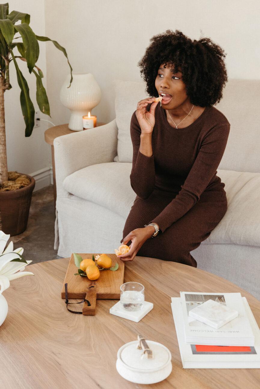 Woman eating citrus.