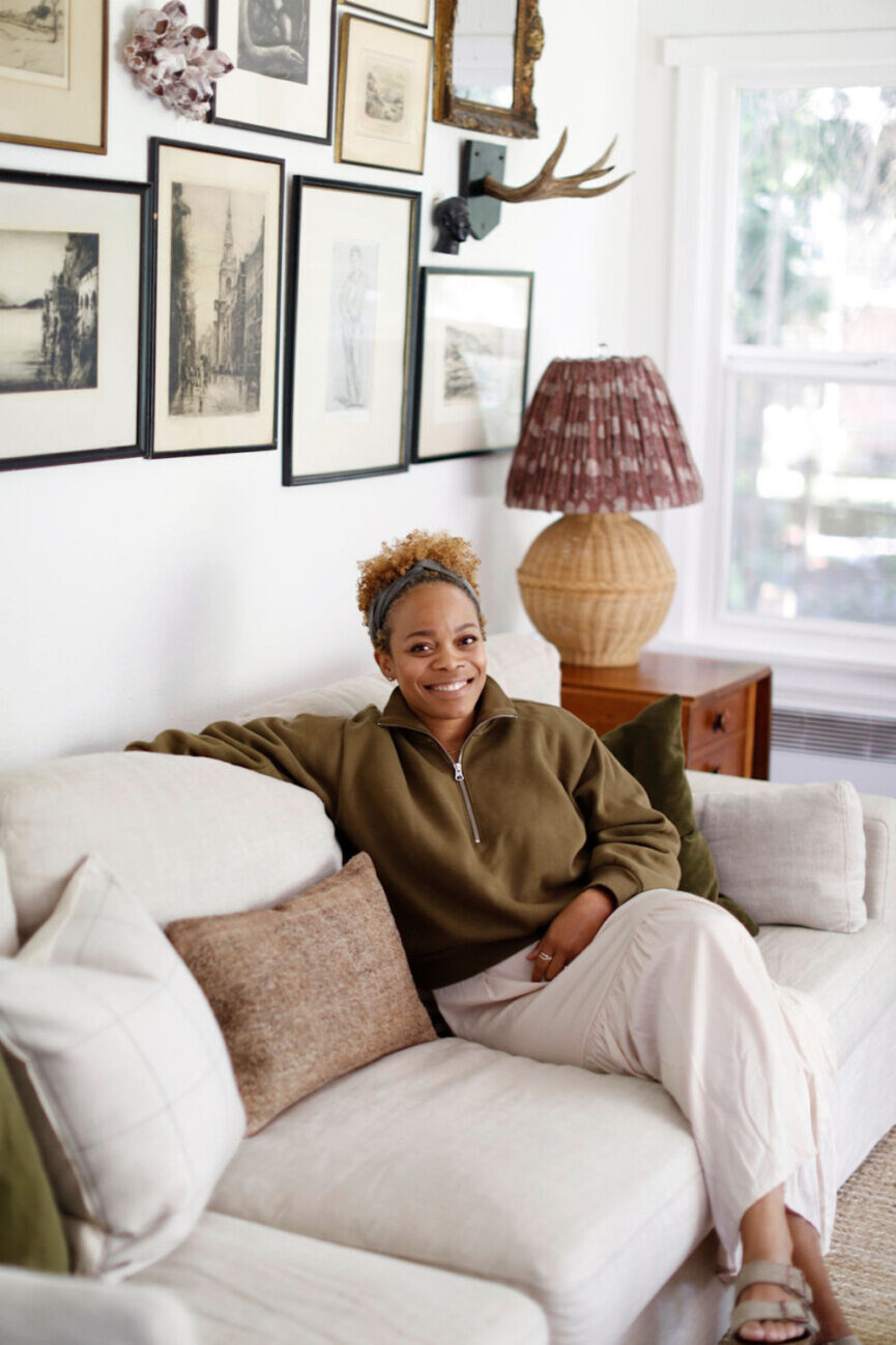 Woman sitting on couch.