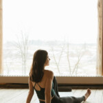 Woman sitting on yoga mat.