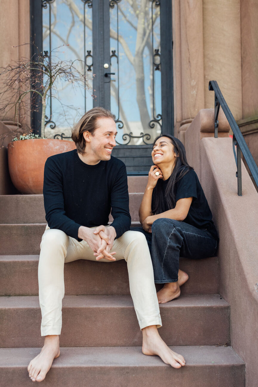 Couple sitting on city stoop.