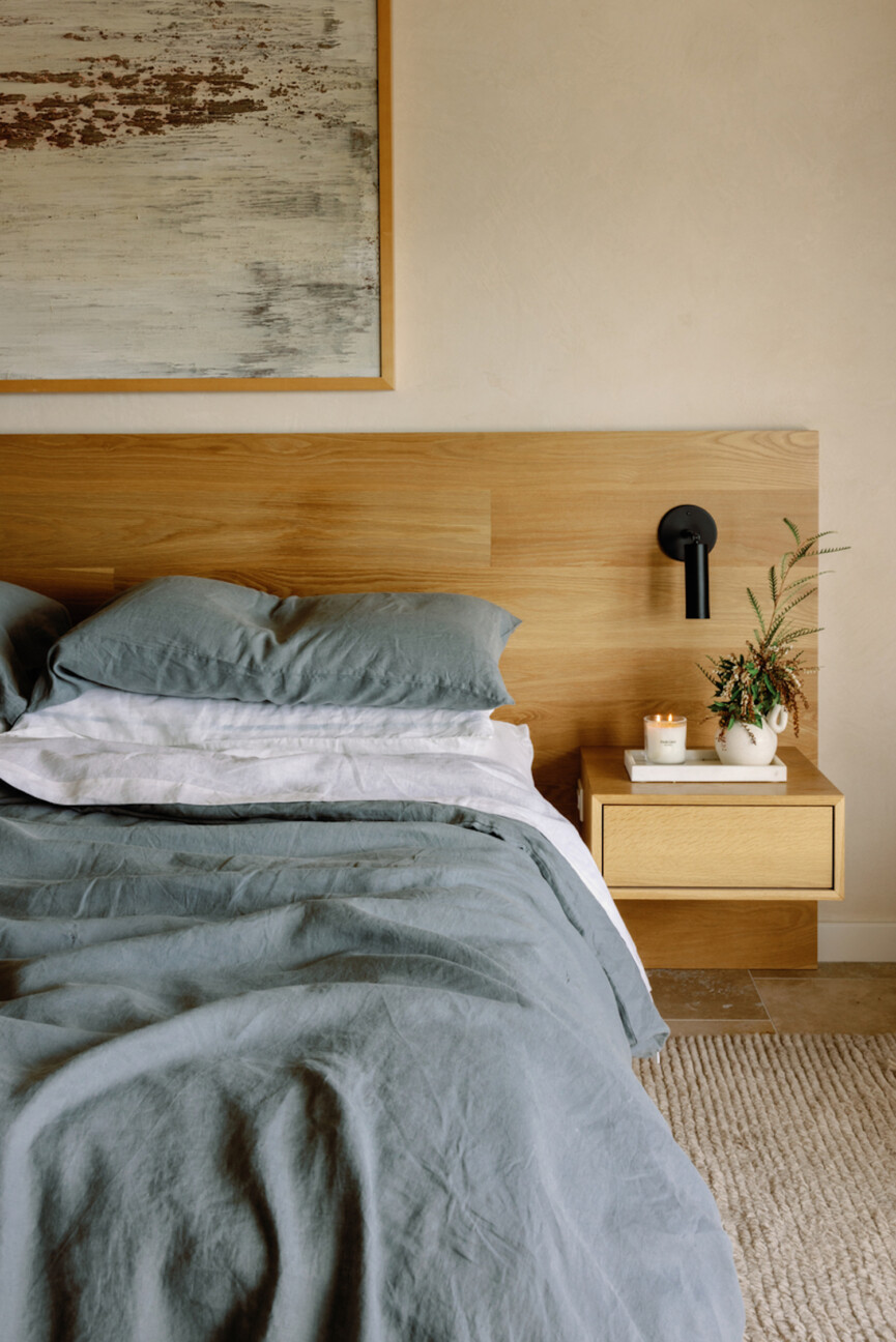 Minimalist bed blue sheets.