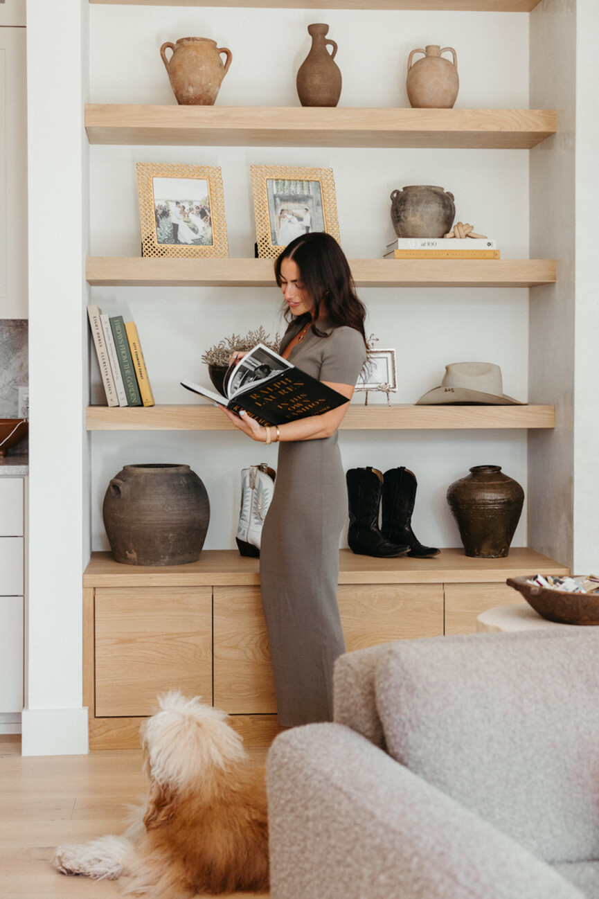 Sami Spalter reading book off bookshelf.