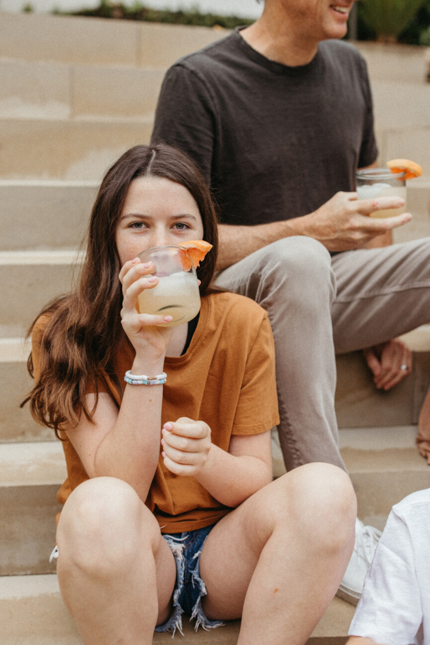 Girl drinking sparkling grapefruit drink.