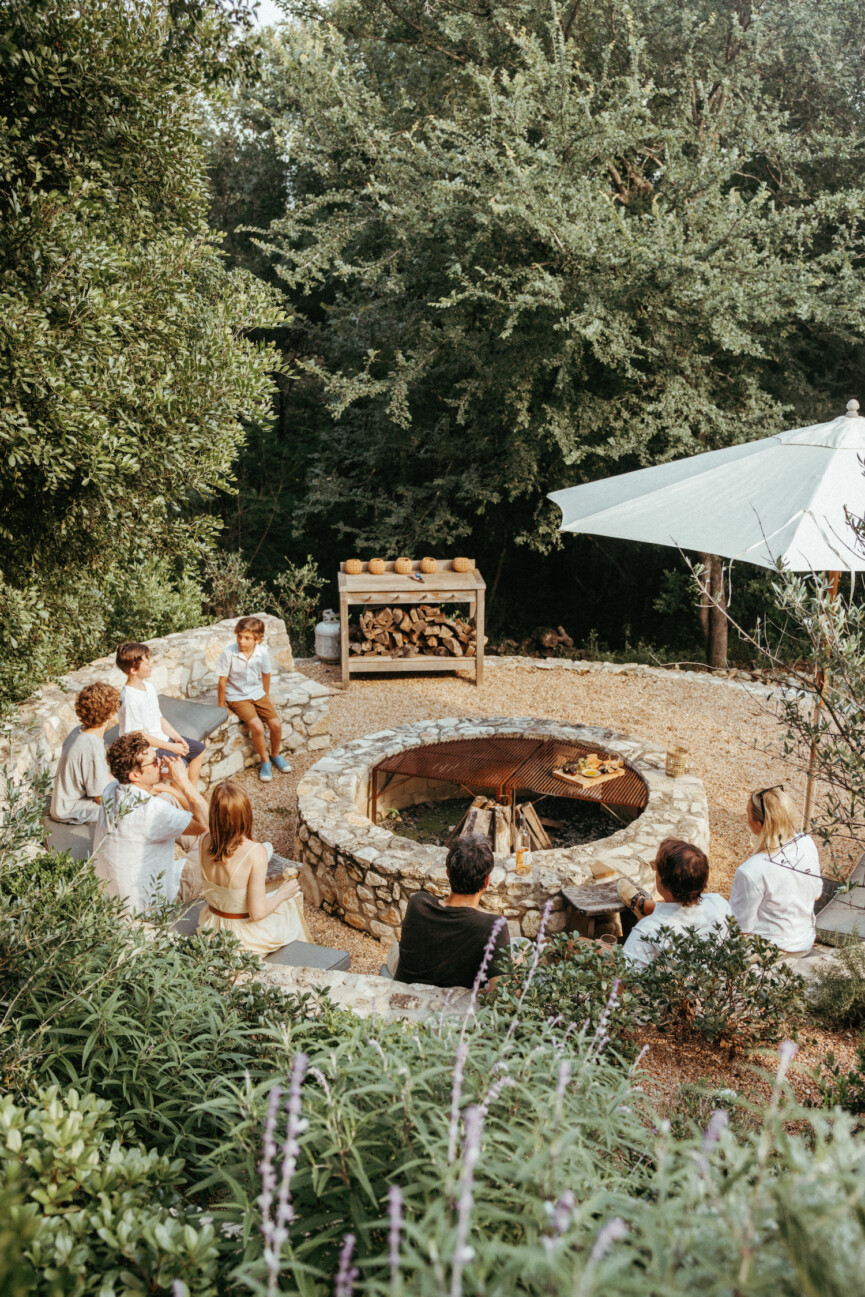 group outdoors around fire pit_outdoor dinner party menu ideas