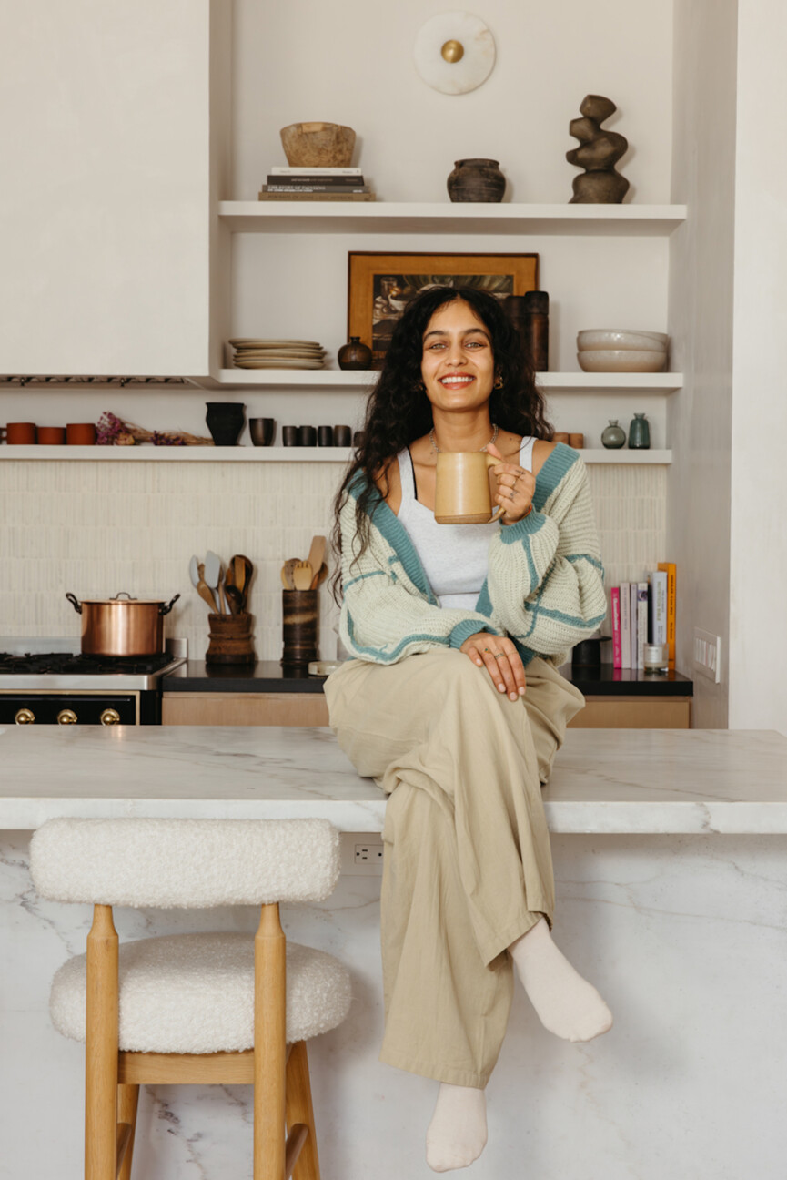 Woman drinking coffee in kitchen