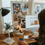 Woman writing list at desk.