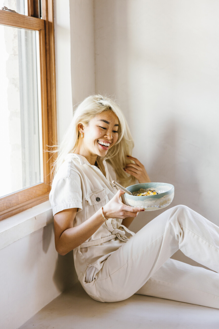Woman eating grain bowl.