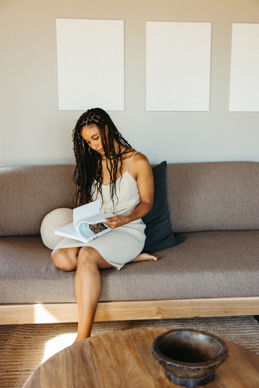 Woman reading on couch.