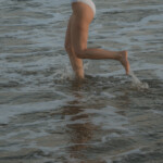 Woman running in water.