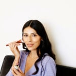 Woman using blush stick.