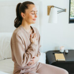 Megan Roup meditating on bed_biological age