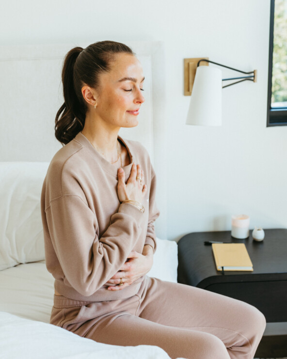 Megan Roup meditating on bed_biological age