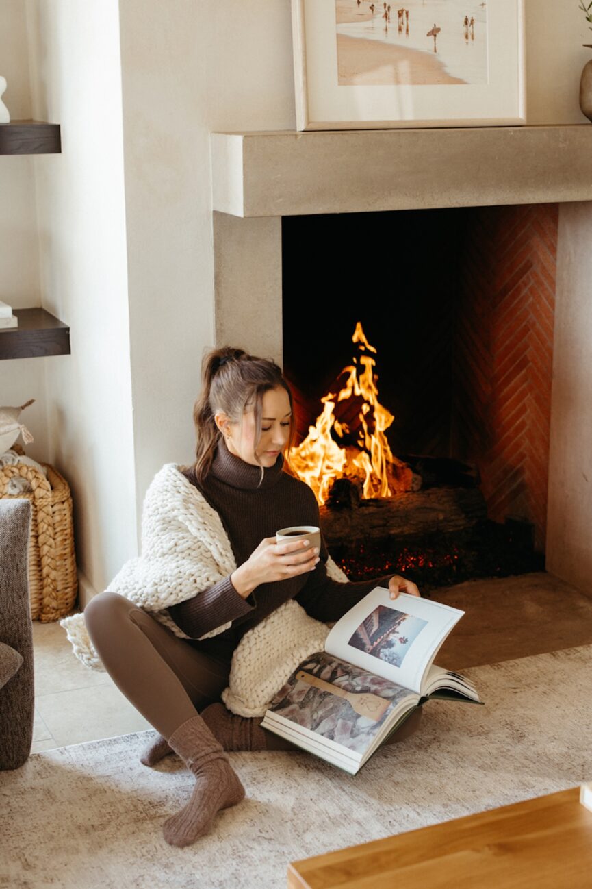 Woman reading book of ideas for things to do in October.