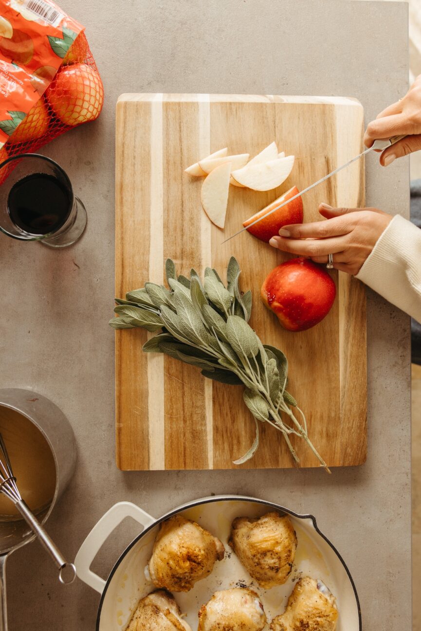 cutting apple on cutting board_cider glazed chicken thighs