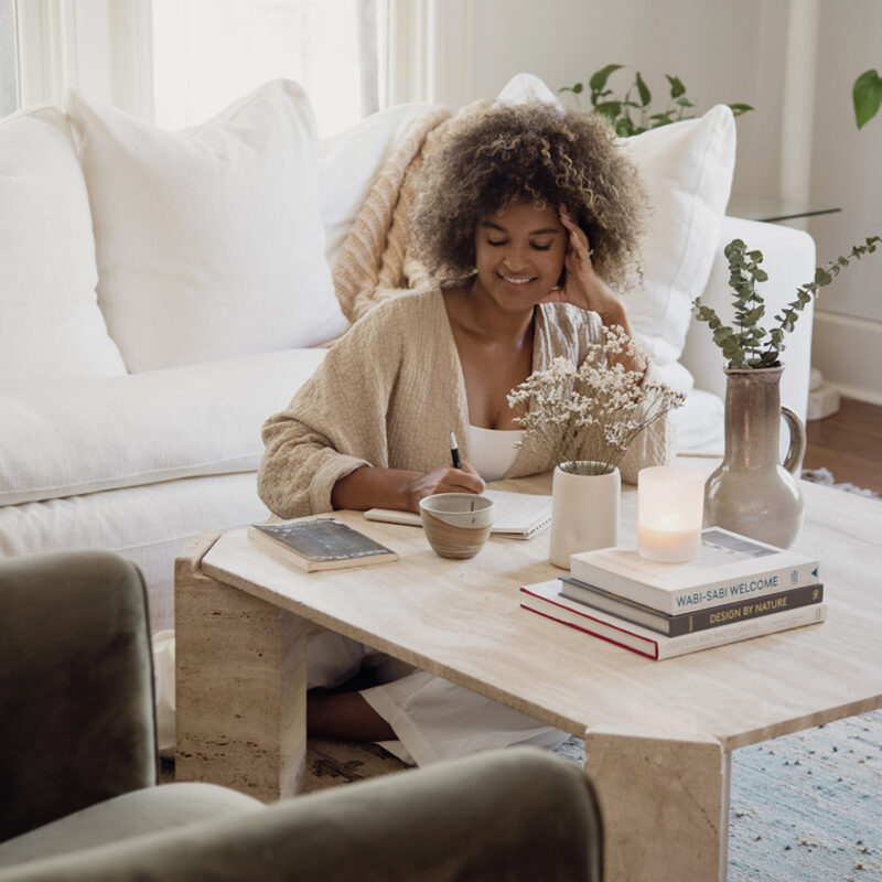 woman journaling in living room