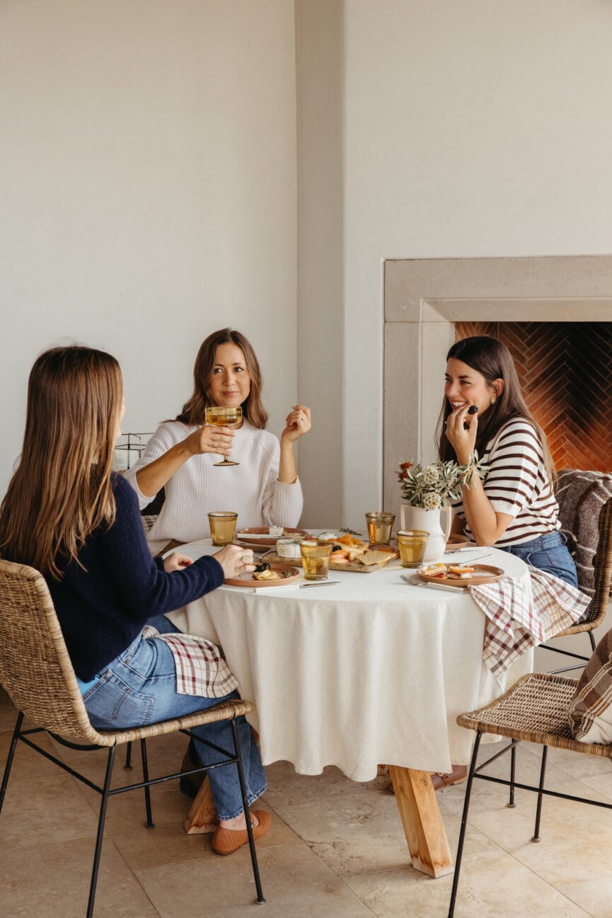 friends gathered around table for fall happy hour