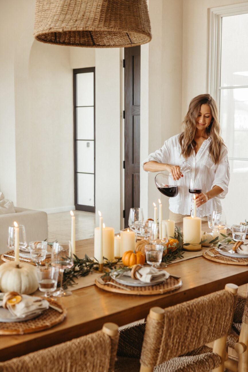 Camille Styles pouring wine at Thanksgiving