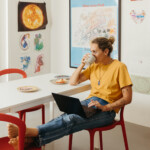 woman doing digital declutter sipping coffee in colorful kitchen