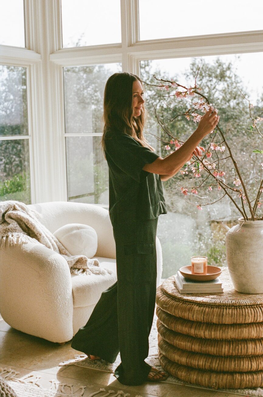Camille Styles arranging branches in vase